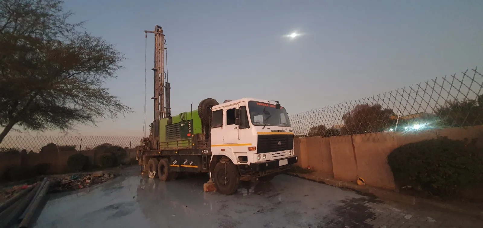Drill rig truck at dusk – borehole infrastructure ready for deployment